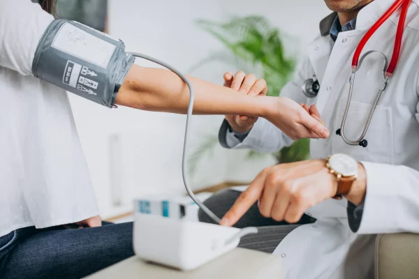 young-male-psysician-with-patient-measuring-blood-pressure-3-scaled young-male-psysician-with-patient-measuring-blood-pressure-3-scaled